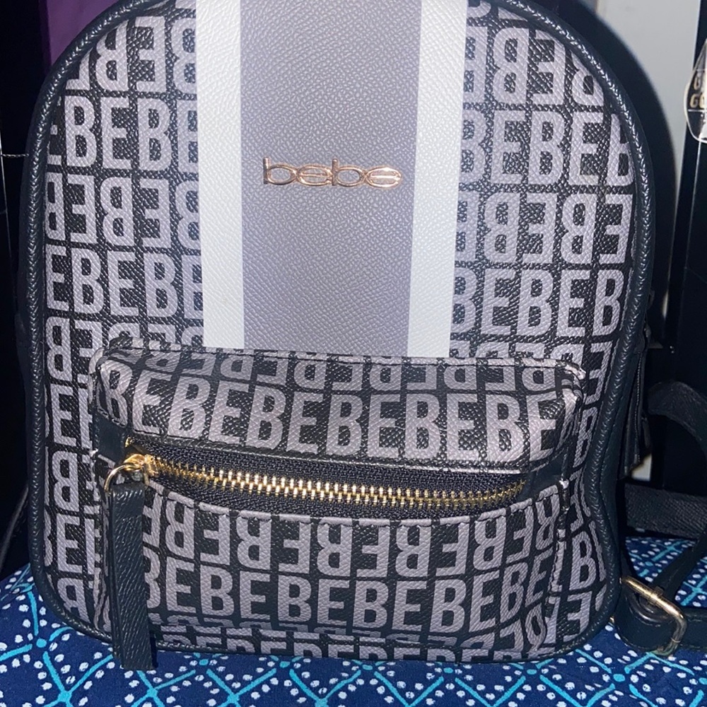 Used black,grey, and white bebe mini book bag. All zippers work, bag is intact